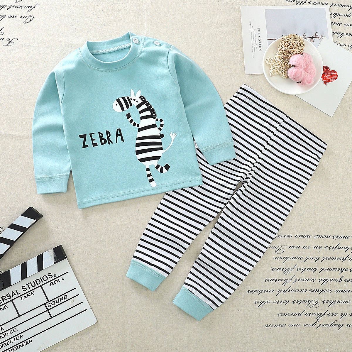 Black and white striped long-sleeve shirt with a small embroidered logo on the chest