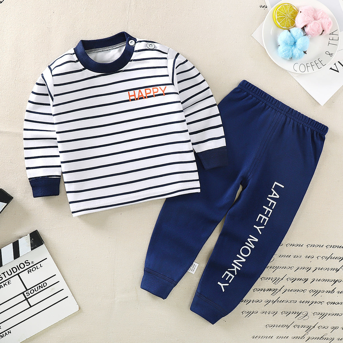 Black and white striped long-sleeve shirt with a small embroidered logo on the chest