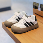 Image of a black and white sneaker with a thick sole and a modern design.