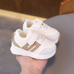 Image of a black and white sneaker with a thick sole and a mesh upper.