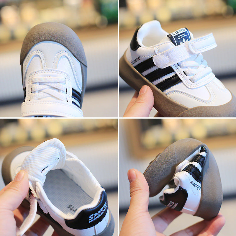 Black and white striped long-sleeve shirt with a small embroidered logo on the chest
